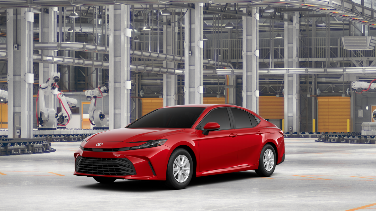 2026 Toyota Camry LE in Supersonic Red — front three-quarter view