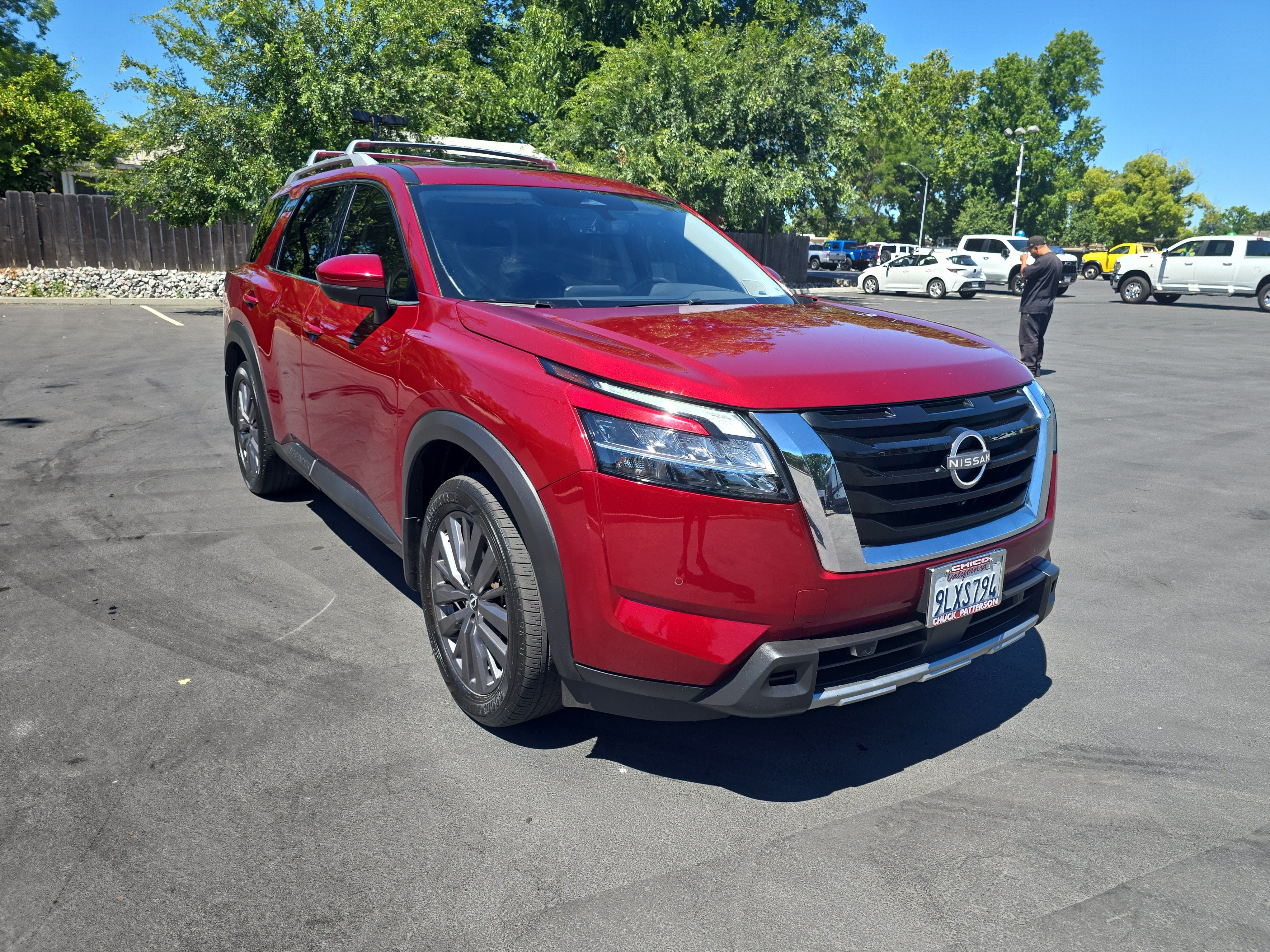 2024 Nissan Pathfinder SL in Scarlet Ember — front three-quarter view
