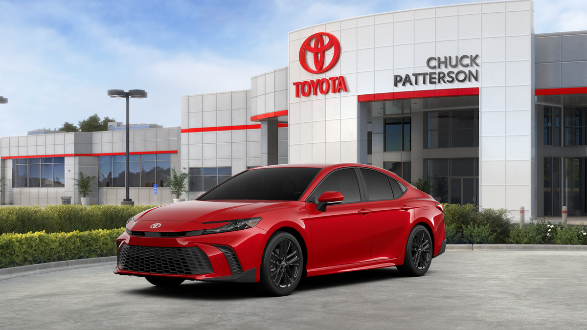 2026 Toyota Camry SE in Supersonic Red — front three-quarter view